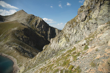 Landscape of highland lake high in the mountains of Dombai. Circus formed by a glacier with a deep lake and blue water