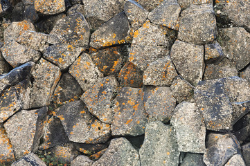 Textured basalt background hexagonal stone pillars in a section. natural volcanic formations
