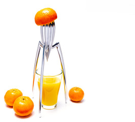 Orange juice squeezed with a fancy stainless steel juicer on a white background