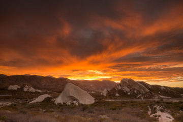 A fiery sunset over the Mormon Rocks along Interstate 15 in the Cajon Pass in the Angeles Mountains CA.