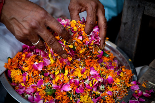 Haridwar, India: Floating offerings are prepared and will be set onto the Ganges at nightfall.