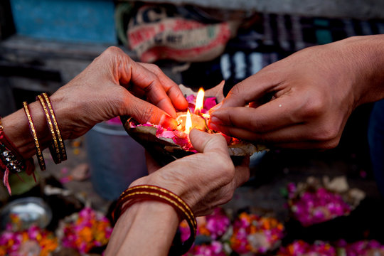 Haridwar, India: Floating offerings are prepared and will be set onto the Ganges at nightfall.