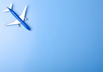 Blue model plane,airplane on color blue background, top view