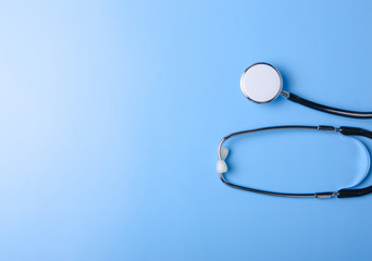 Medical Concept. Top view of stethoscope on blue background. Flat lay and copy space