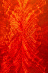 A closeup of a book matched mahogany veneer on a door of a cabinet.