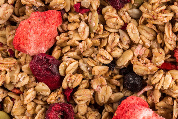 Muesli oat cereals close up background with dry fruits