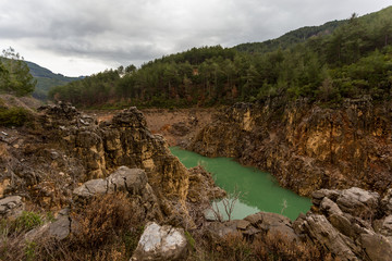 Turqoise lake surrounded by hills with steep slopes