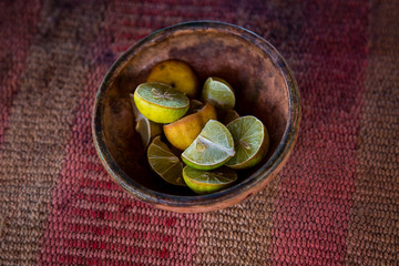 Composition of lime fruits on rustic background in a bowl