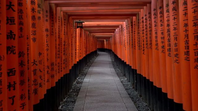 Walking inside Fushimi Inari Taisha, a Shinto shrine in Kyoto, Japan.