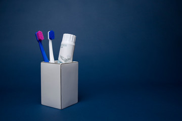 Colorful toothbrushes on a dark background - obrazy, fototapety, plakaty