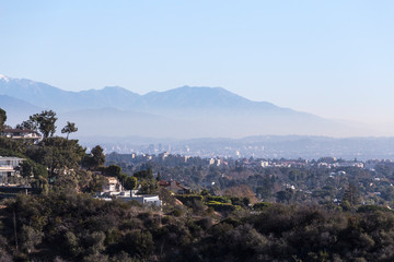 Smoggy morning cityscape view of hillside homes with Hollywood, Los Angeles and the San Gabriel...