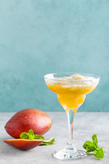 Refreshing summer mango cocktail with fresh juice and ice cream