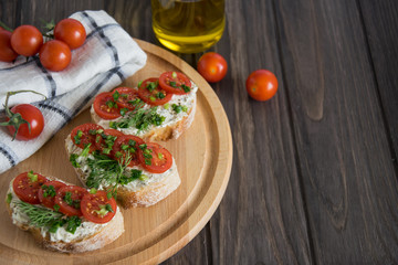 Bruschetta with tomatoes and herbs on a wooden plate, Italian food appetizers