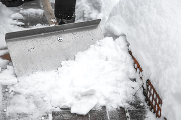 Snow removal with an iron shovel.