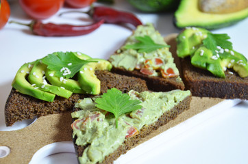 Guacamole and bread. Toast with avocado on white background. Homemade Mexican healthy vegan food