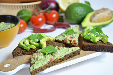 Guacamole and bread. Toast with avocado on white background. Homemade Mexican healthy vegan food