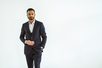 The businessman in a beautiful suit standing on the white background