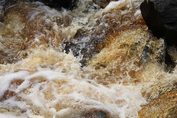 the river flows through a rocky pass, the water of a stream