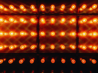 Many bright glowing glass lamps. Illumination of set Edison retro lamps on dark rabitz background....