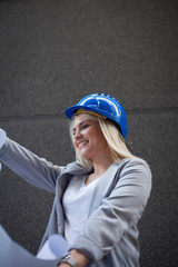 Construction workers and architect looking at blueprints.