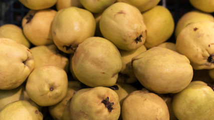 Top view of fresh pears yellow colour in the market. Yellow pears for sale. Background image of pears for shop
