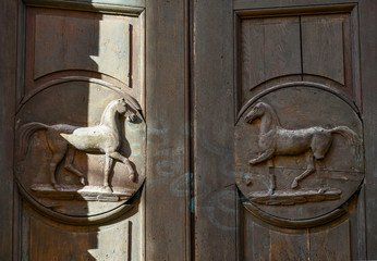 Detail of an ancient wooden door inside the Cavallerizza Reale (Royal Riding School), an architectural work begun by Amedeo of Castellamonte and finished by Benedetto Alfieri in 1741 - obrazy, fototapety, plakaty