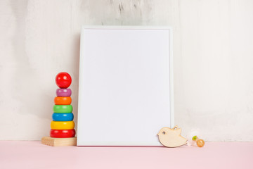 Festive mood, baby toys with white empty frame for layout design. Baby shower