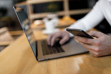 Male hands typing on laptop closeup.