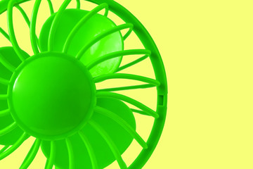 Green fan on a yellow background