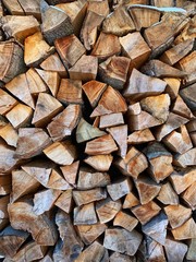 Close-up of tree trunks cut of firewood stacked and ready for burning in the winter