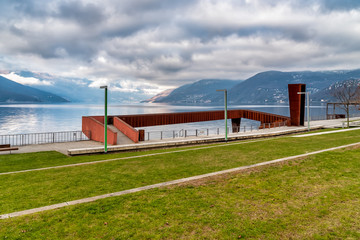 Landscape of Lake Maggiore in cloudy day from lakefront of Luino, province of Varese, Italy