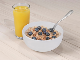 Oatmeal with blueberries and cinnamon and orange juice.
