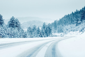 Mountain road landscape covered in snow in winter  © disq