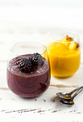 Colorful yellow and blue smoothie in two glasses