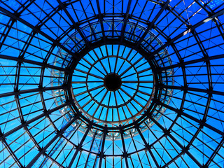 Silhouette top center circle ceiling dome roof white steel structure architecture, round dot shadow, distributed line surround, transparent clear glass wall with reflection, bright blue sky background