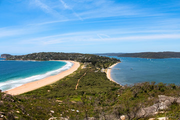 Fototapeta na wymiar Palm Beach in Sydney as seen from Barrenjoey Head viewpoint on a clear summer day with perfect beach views (Sydney, Australia)