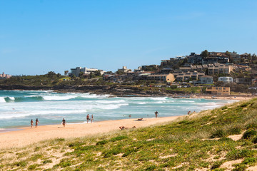 Curl Curl Beach, one of Sydney's Northern beaches, on a clear summer day with surfers, big waves,...