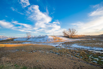 winter landscape with stream and blue sky