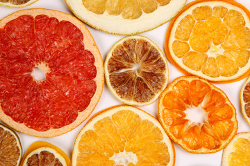 Fototapeta na wymiar Dried slices of various citrus fruits on white background