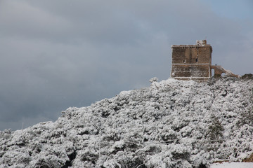 Santa Caterina tower after a exceptional snowfall, Salento, Italy