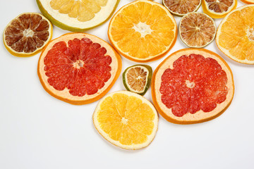 Fototapeta na wymiar Dried slices of various citrus fruits on white background