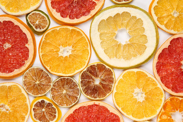 Dried slices of various citrus fruits on white background