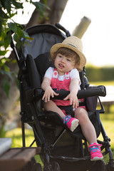 baby girl sitting in the baby stroller