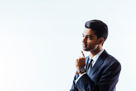 Portrait Of A Businessman Thinking With Finger Near Chin  And Looking To Side, Isolated On White Studio Background..