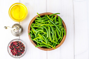 Healthy natural seasonal food. Arrows young fresh garlic chopped into many sticks in wooden bowl on white background