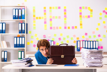 Young employee suffering from excessive work  