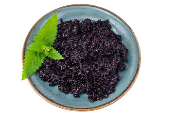 Cooked black rice on blue plate