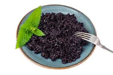 Cooked black rice on blue plate