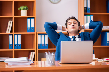 Young handsome businessman working in the office