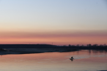 Boat at sunset on the river Po
